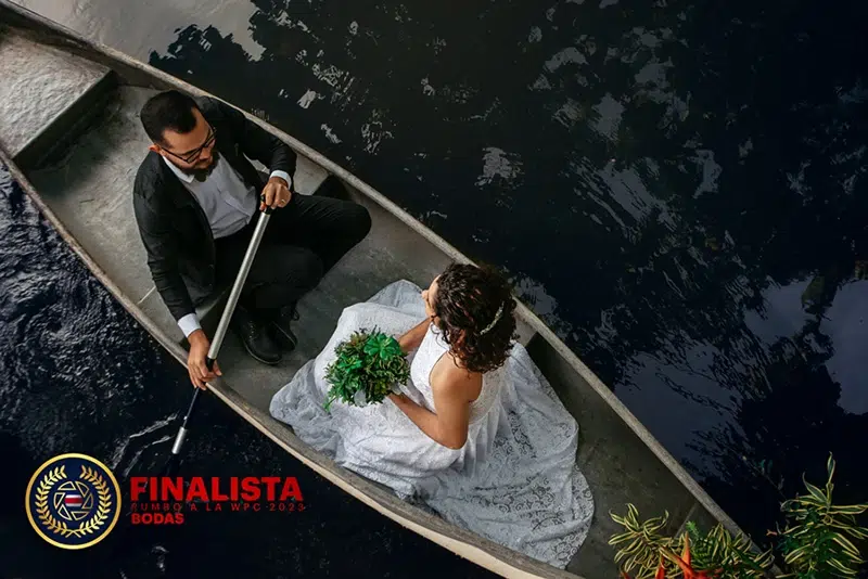Canoe wedding photo on tranquil waters Bride and groom in a canoe on dark water in Costa Rica