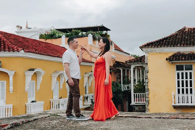 Joice & Diego: Capturing love, living it too Wedding photographers Joice and Diego dancing together in a cobblestone street in Cartagena, Colombia