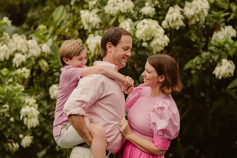 Carried by love, grounded by family Father carrying his son on his shoulders next to the mother in Costa Rica