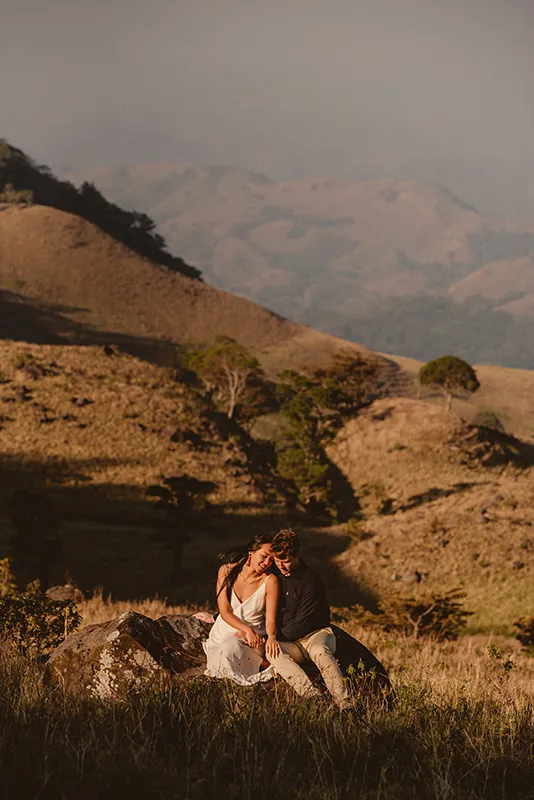 Engaged couple hugging at golden hour in Costa Rica