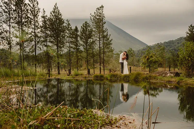 Romantic Kiss Reflected in Water – Arenal Volcano Couple kissing with their reflection on the water in front of Arenal Volcano.