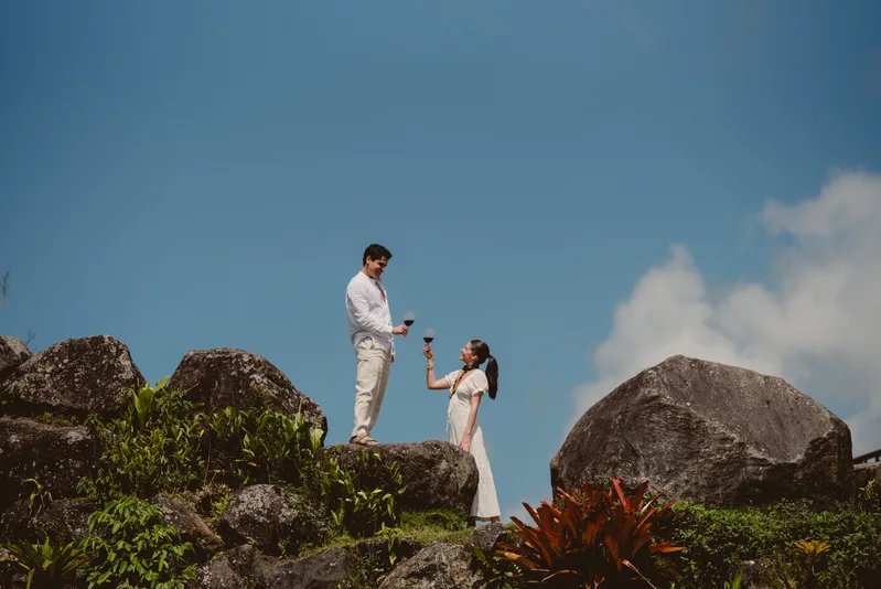 Costa Rica wedding & elopement photographer capturing a couple embracing on a coastal cliff at sunset