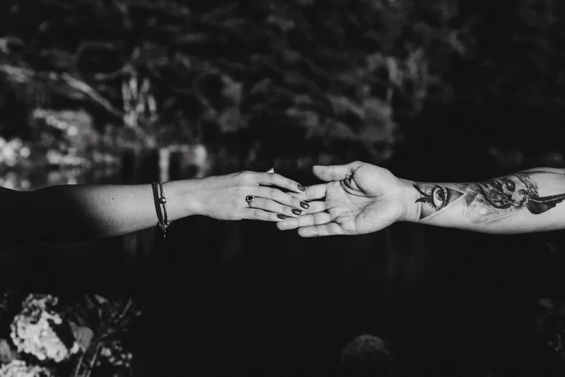 Black and white detail shot by a Costa Rica wedding & elopement photographer of the couple's hands and wedding rings