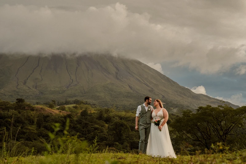 La Fortuna wedding photographer image of newlyweds standing together with Arenal Volcano in the background, Costa Rica