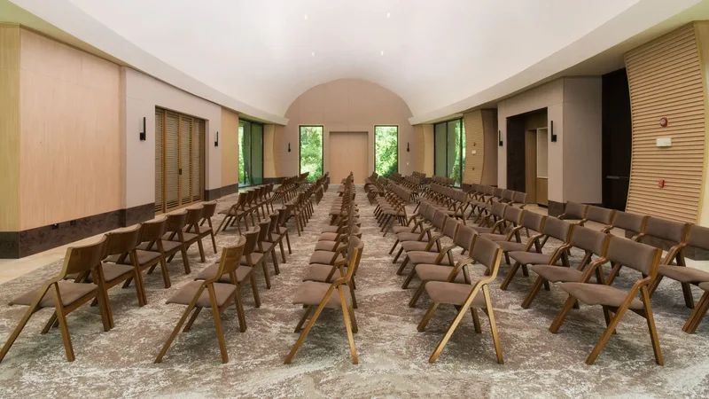 Indoor event studio set with rows of wooden chairs for a wedding ceremony at Andaz Costa Rica Resort