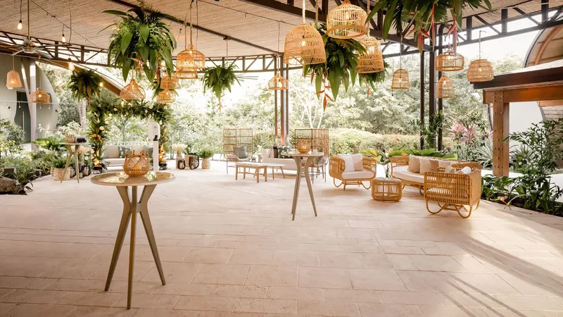 El Patio covered terrace with rattan lamps and cocktail tables at Andaz Costa Rica Resort, Guanacaste