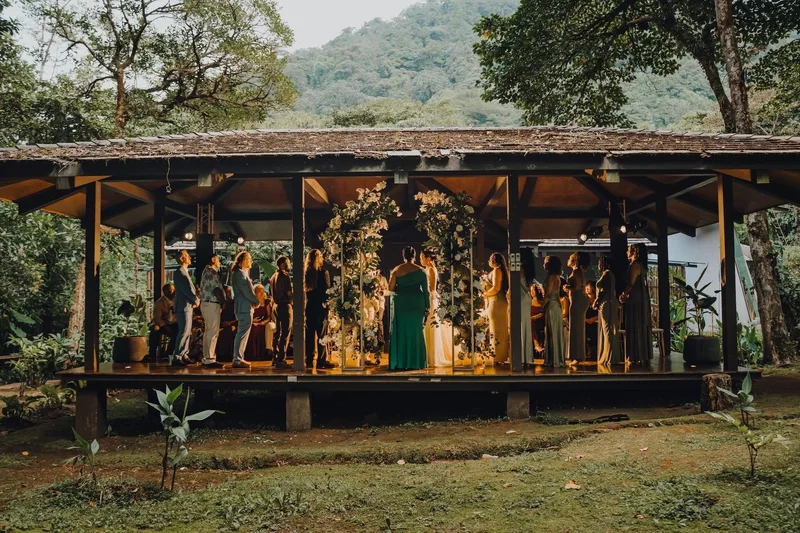 Wedding party gathered under an open-air wooden pavilion in the cloud forest at El Silencio Lodge & Spa, Bajos del Toro, Costa Rica