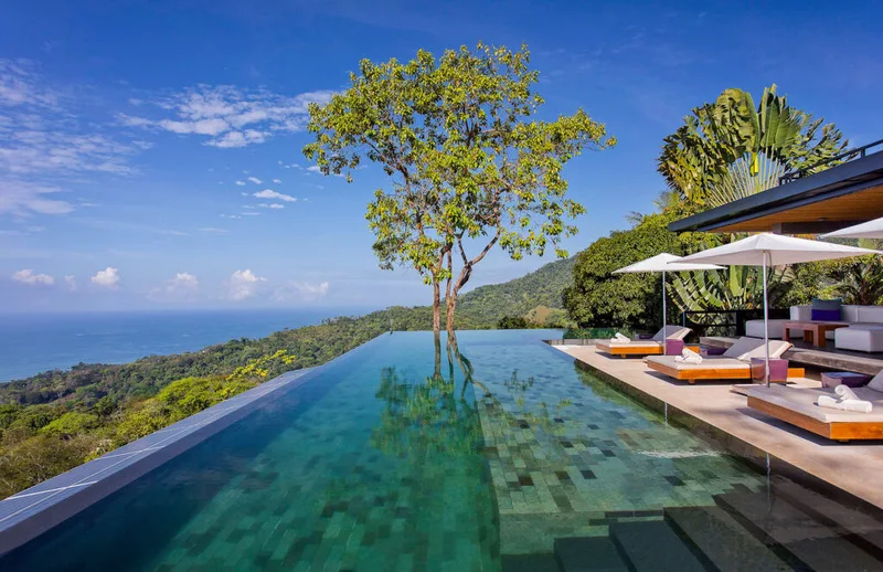Infinity pool with a lone tree and ocean view at Kura Boutique Hotel, a wedding venue in Uvita, Costa Rica