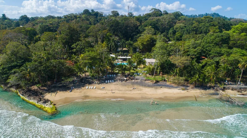 Aerial view of Playa Cocles beach and the rainforest surrounding Le Caméléon Hotel on the Caribbean coast of Costa Rica
