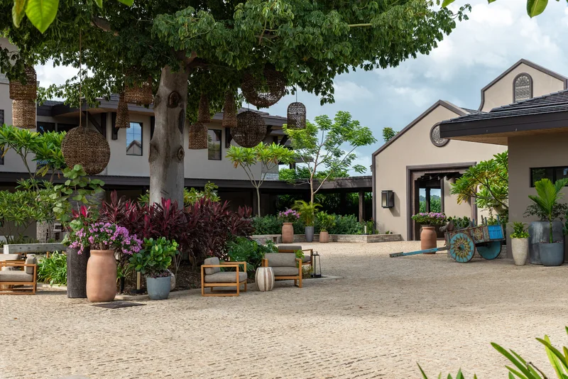 Hacienda-style courtyard with lounge seating and hanging woven lanterns at Nekajui, a Ritz-Carlton Reserve in Guanacaste, Costa Rica