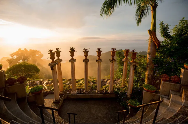 Golden sunset over the Pacific seen from the columns of the Villa Caletas amphitheater, a wedding venue in Jacó, Costa Rica